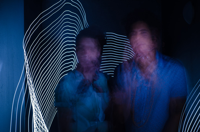 The two men band ‘The Cosmic Race’ blured by light painting.