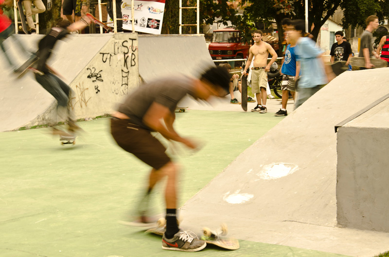 Skateboarders caught in movement.